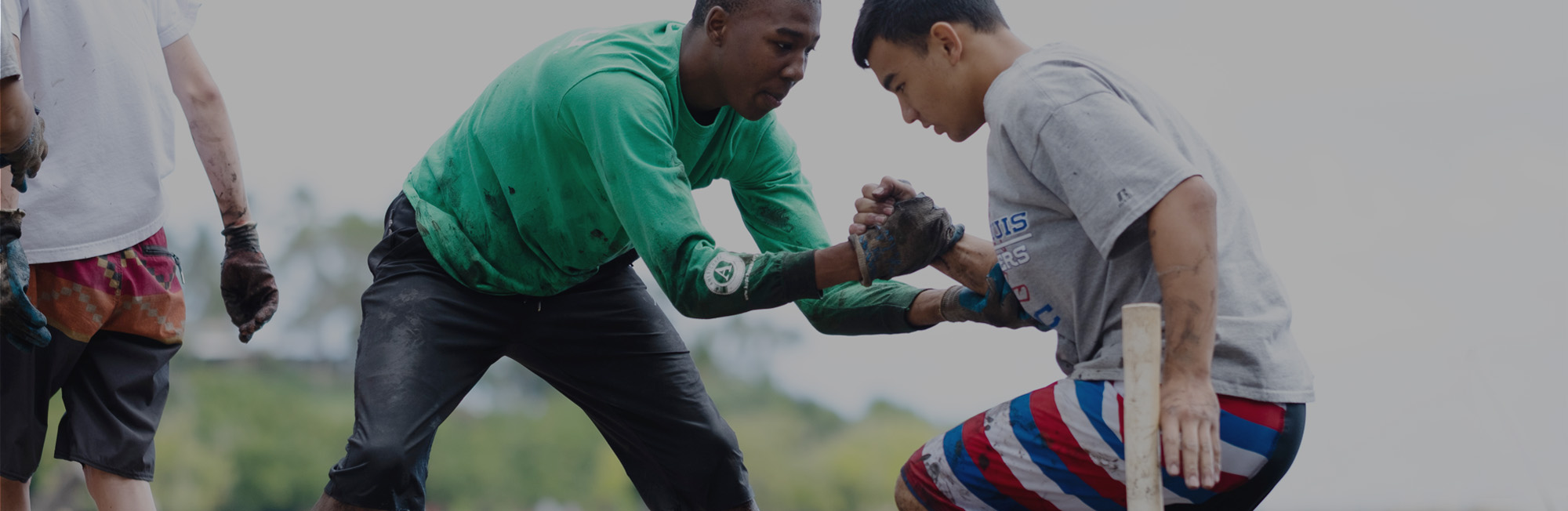 A young man helps another. Text over the image reads The Change Framework.